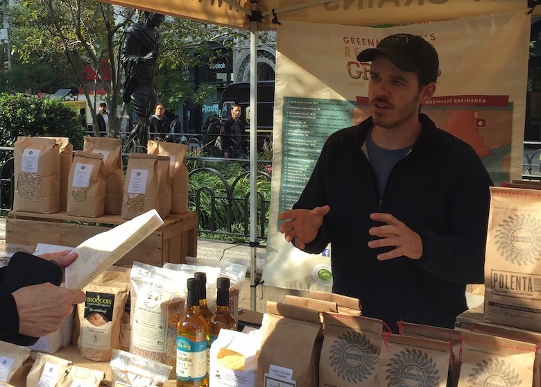 person describing regional grains under tent