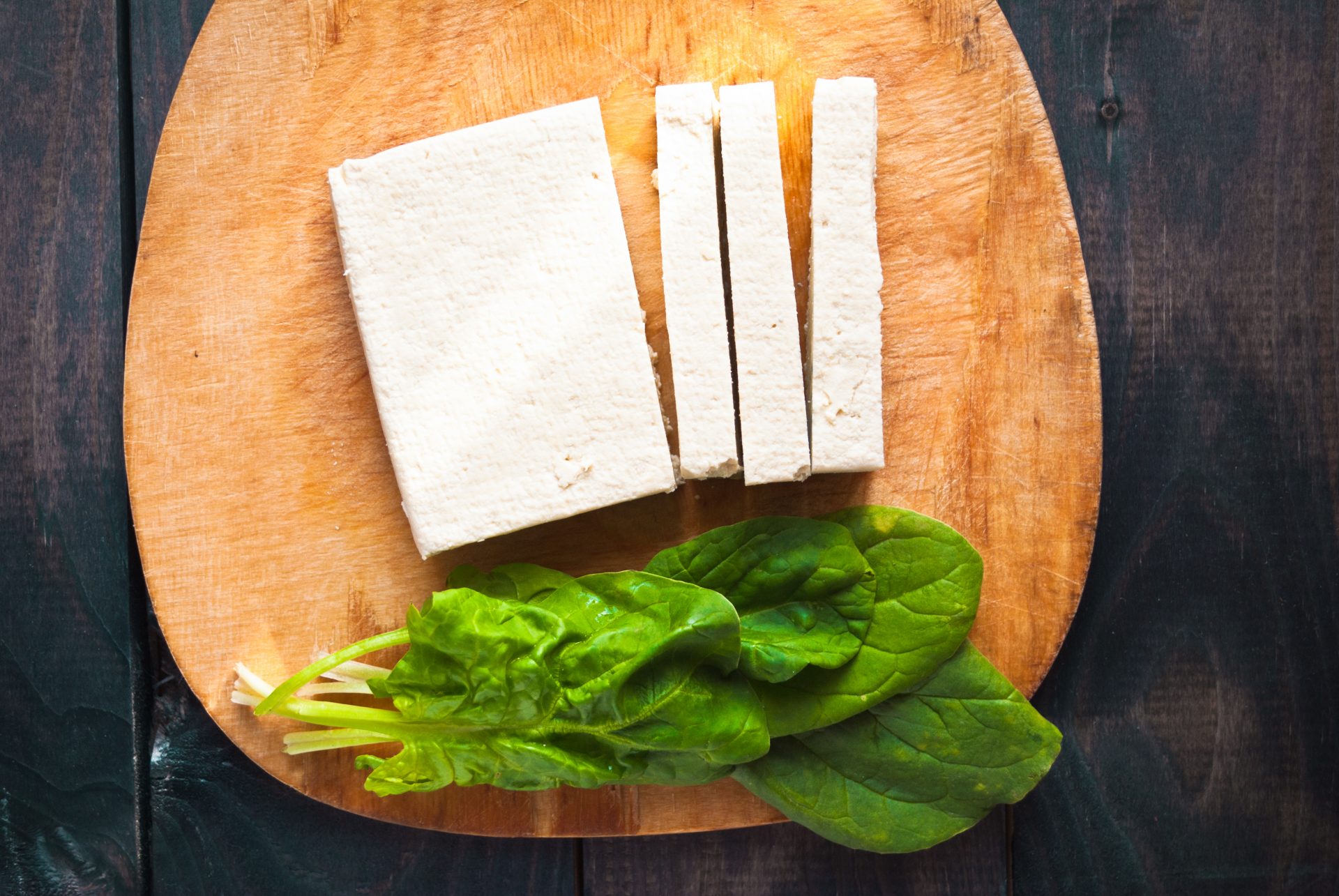 Slices of raw tofu and spinach