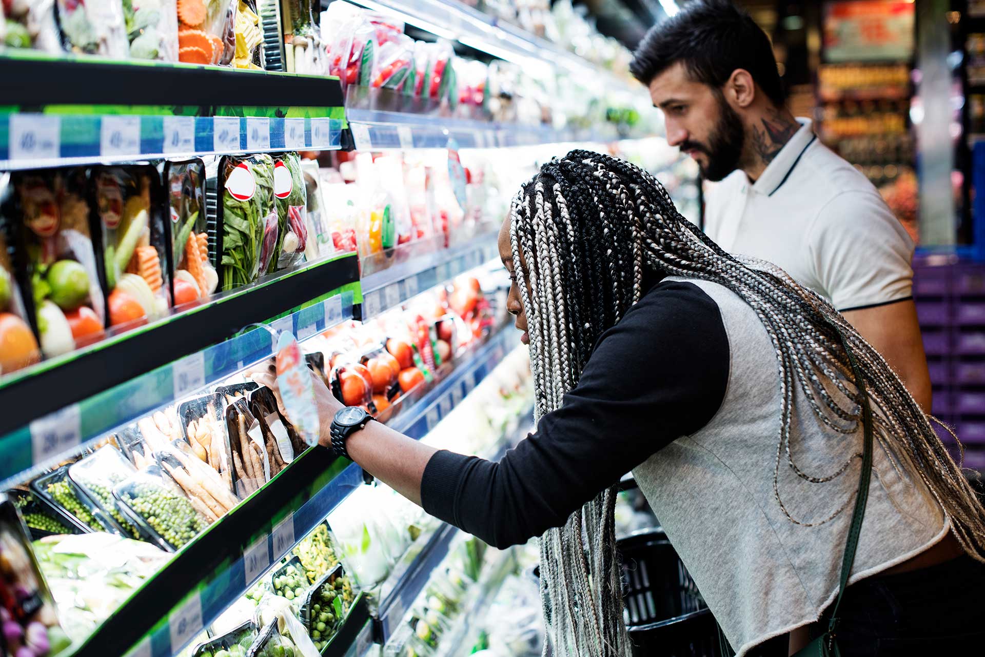 Image by RawPixel. Woman and man shopping for groceries.