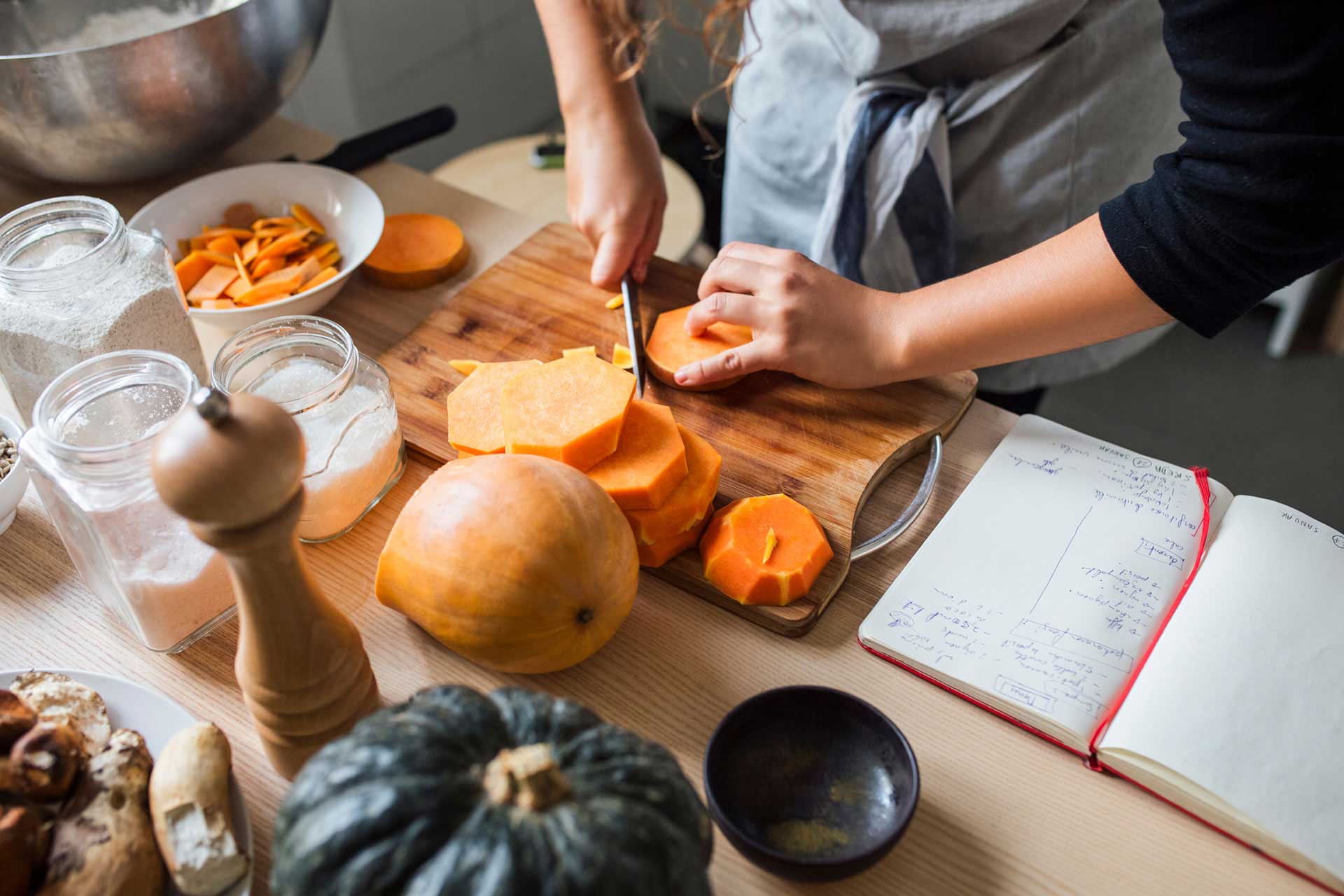 person cutting butternut squash