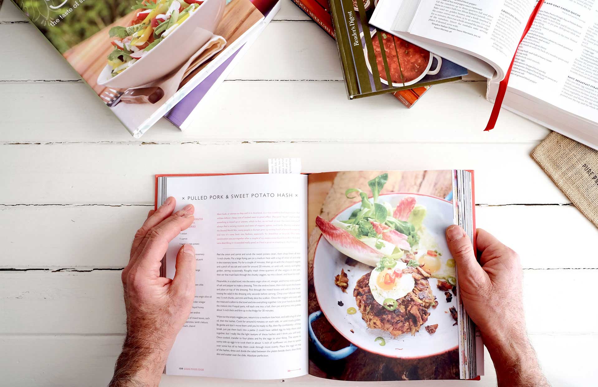 person looking at cookbooks