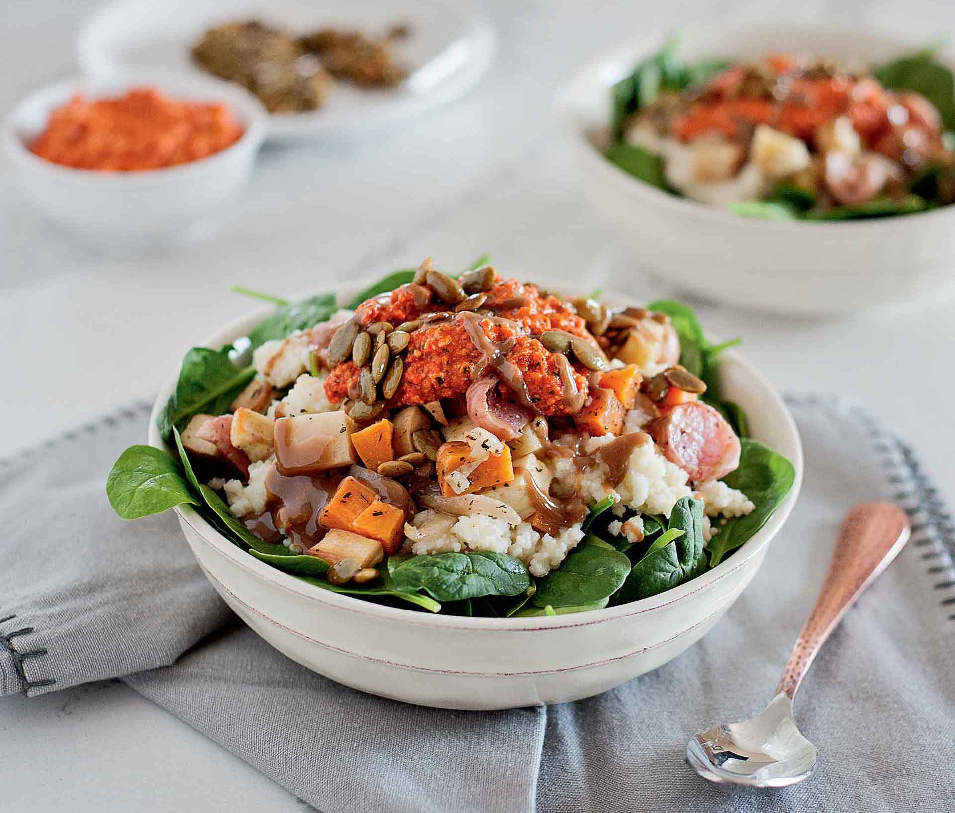 bowl of roasted squash, spinach, sunflower seeds