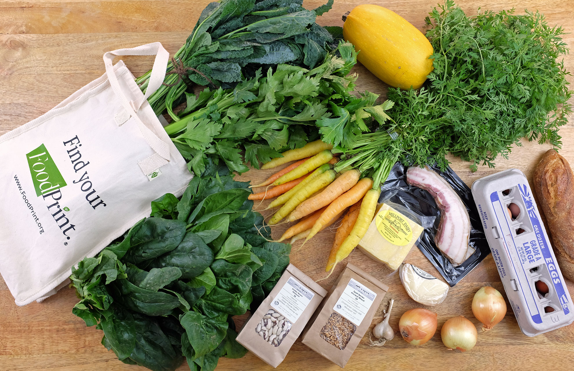 canvas bag with fresh greens, carrots, eggs, bacon, and greens