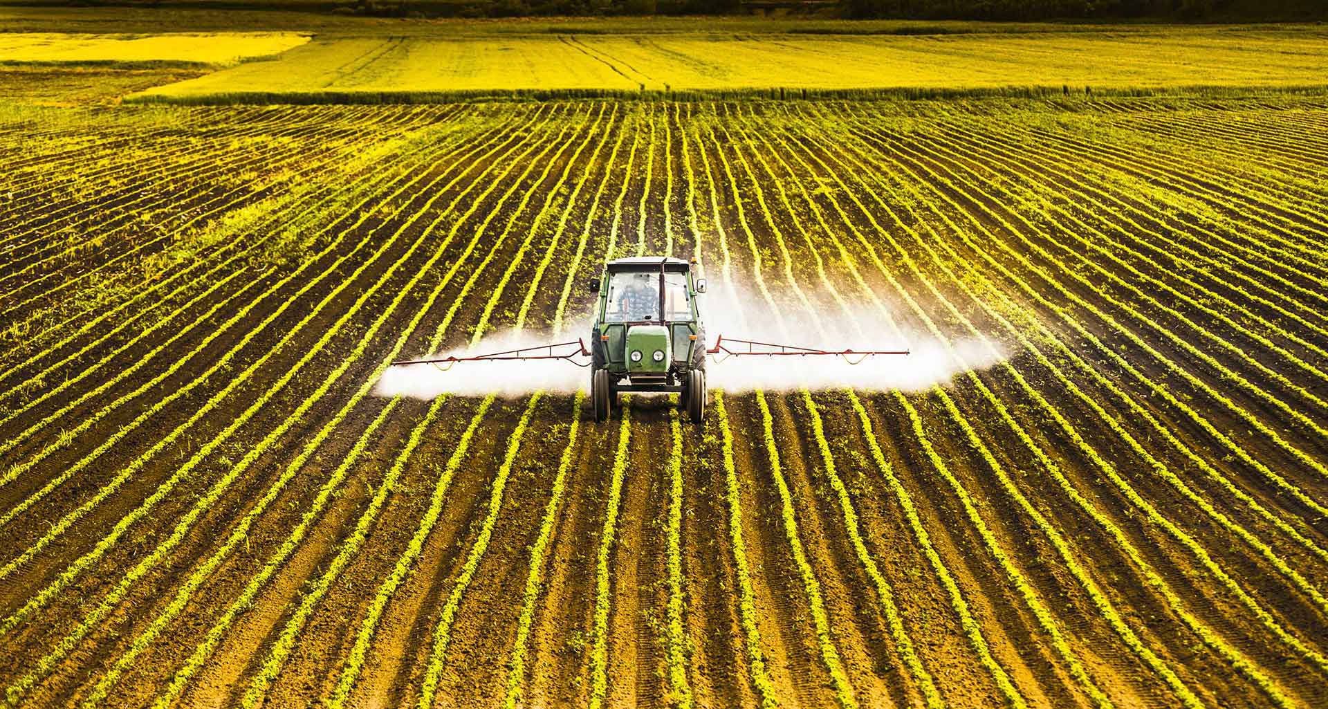 tractor spraying a field with glyphosate