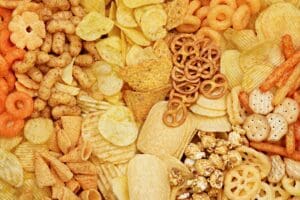 variety of ultraprocessed foods including pretzels, potato chips, cheese curls, sweet popcorn.