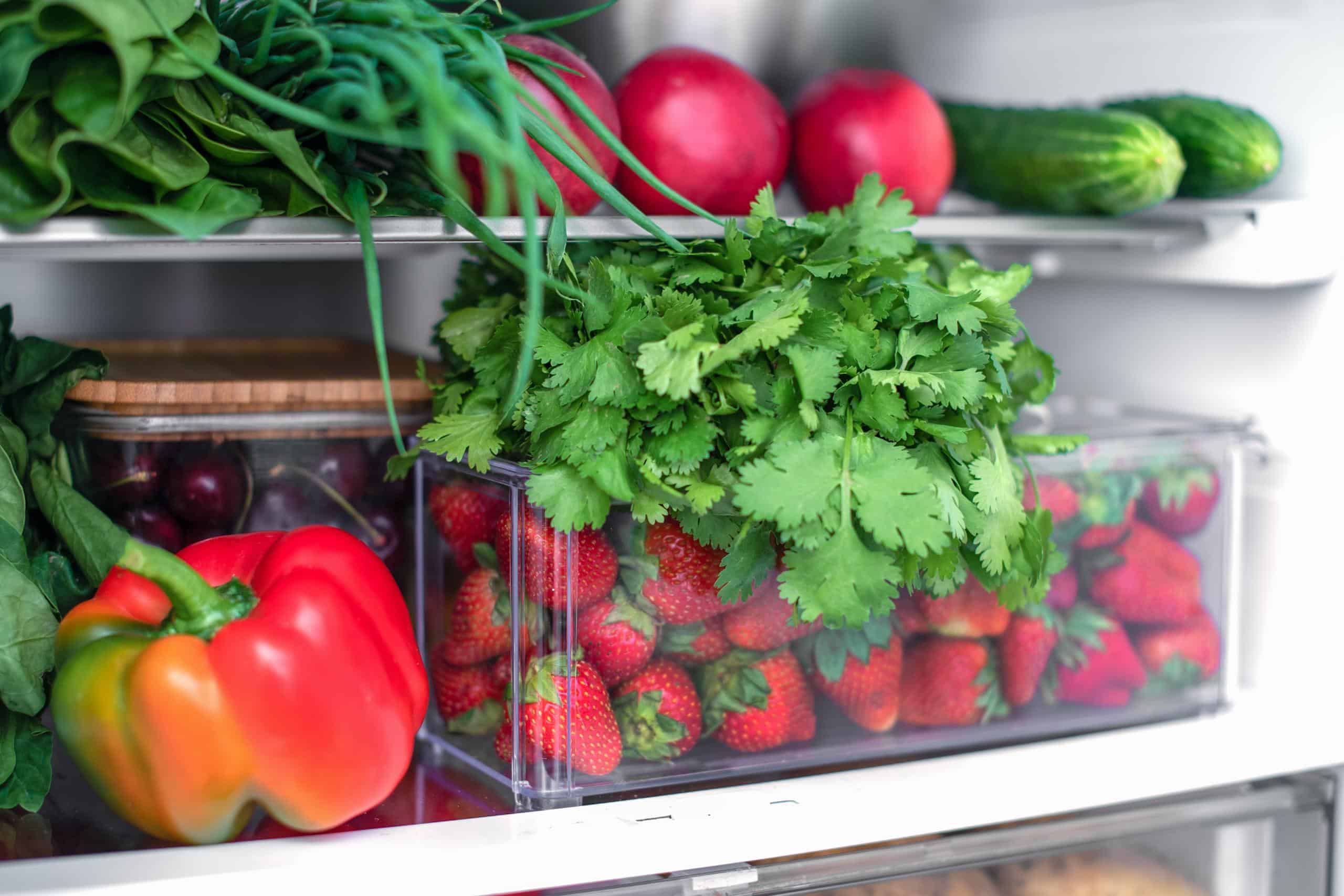 Open fridge full of fresh fruits and vegetables